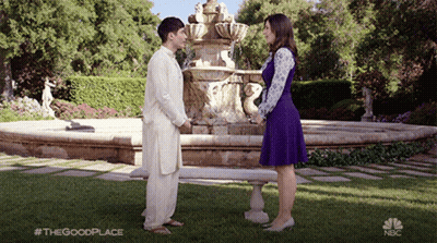 Man And Woman In Front Of Fountain Saying The Good Place GIF
