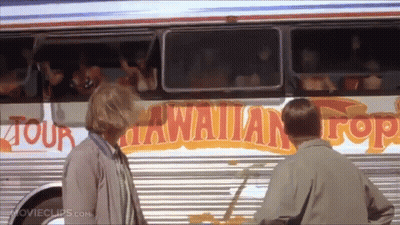 Man And Woman In Front Of Hawaiian Top Bus GIF