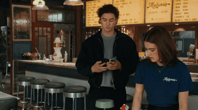 Man And Woman In Front Of Maloney's Diner Bar GIF