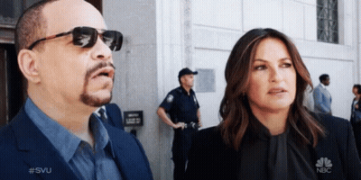 Man And Woman In Front Of NBC Building GIF