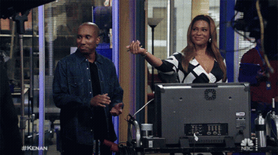 Man And Woman In Front Of NBC Monitor GIF