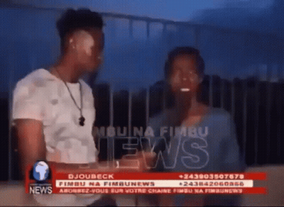 Man And Woman In Front Of News Screen GIF