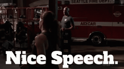 Man And Woman In Front Of Seattle Fire Truck GIF