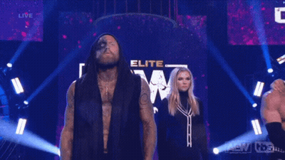 Man And Woman In Front Of Sign Saying A.T.E.W GIF
