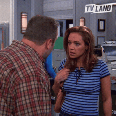 Man And Woman In Front Of TV Land Sign GIF