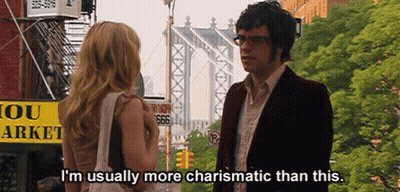 Man And Woman In Front Of Yellow Sign Saying 666 GIF