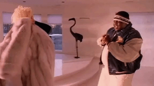 Man And Woman In Fur Coats In Living Room GIF