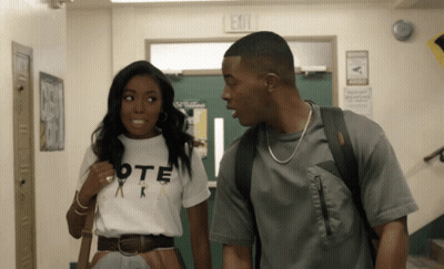 Man And Woman In Hallway With Exit Sign GIF