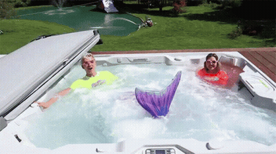 Man And Woman In Hot Tub With Mermaid Tail GIF