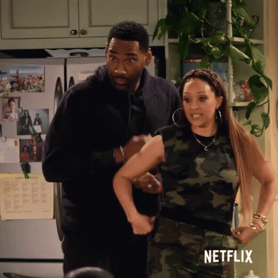 Man And Woman In Kitchen With Netflix Logo GIF