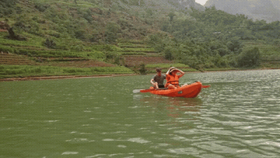 Man And Woman In Orange Kayak Saying Kayak GIF