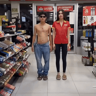 Man And Woman In Store With Te Esperamos Pronto Sign GIF