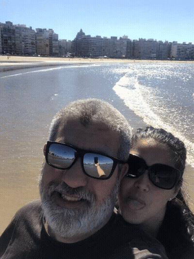 Man And Woman In Sunglasses Posing On Beach GIF