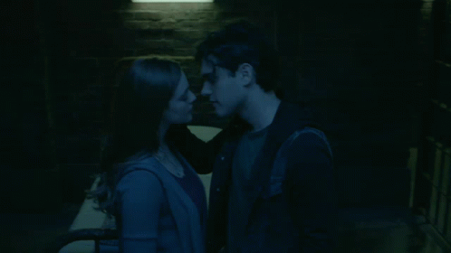 Man And Woman Kiss In Dark Room GIF