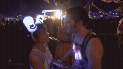 Man And Woman Kissing At Concert GIF
