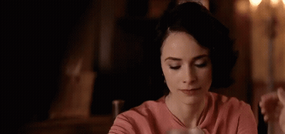 Man And Woman Kissing At Restaurant Table GIF