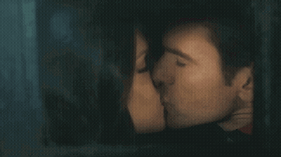 Man And Woman Kissing Behind Window GIF