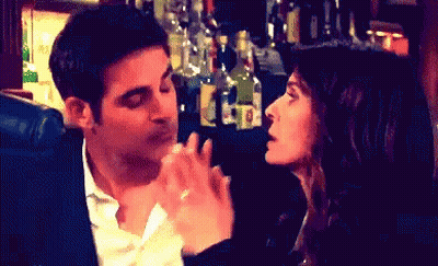 Man And Woman Kissing In Bar GIF