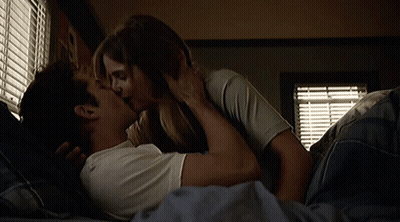 Man And Woman Kissing In Bed GIF