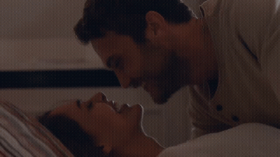 Man and Woman Kissing in Bed Touching Face