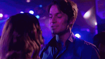 Man And Woman Kissing In Club With Purple Lights GIF