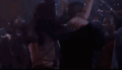 Man And Woman Kissing In Crowded Nightclub GIF