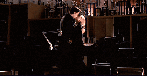 Man And Woman Kissing In Dark Room GIF