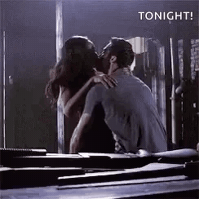 Man And Woman Kissing In Dark Room In Front Of Mirror GIF