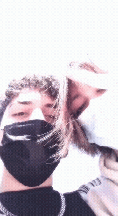 Man And Woman Kissing In Face Masks GIF