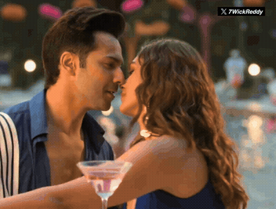 Man And Woman Kissing In Front Of 7Wickreddy Logo GIF
