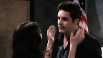 Man And Woman Kissing In Front Of American Flag GIF