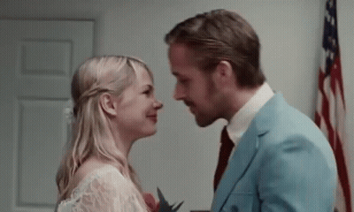 Man And Woman Kissing In Front Of American Flag GIF