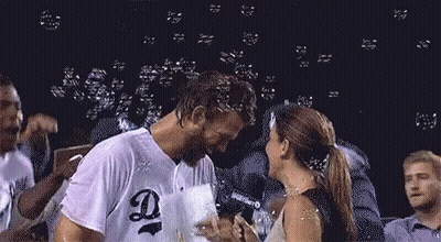 Man And Woman Kissing In Front Of Bubbles GIF