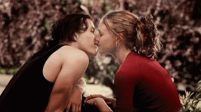 Man And Woman Kissing In Front Of Bush GIF