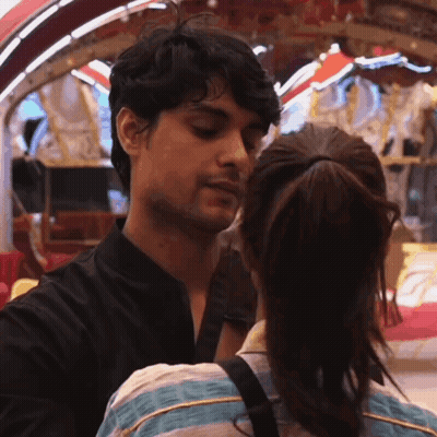 Man and Woman Kissing in Front of Carousel