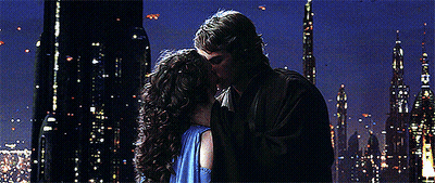 Man And Woman Kissing In Front Of City Skyline At Night GIF