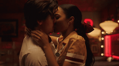 Man And Woman Kissing In Front Of Coca Cola Sign GIF