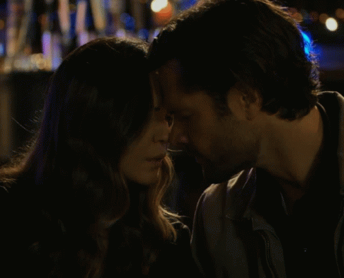 Man And Woman Kissing In Front Of Coca Cola Sign GIF