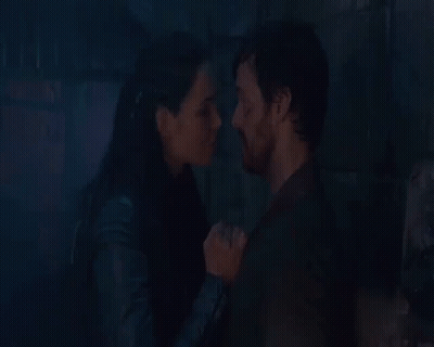 Man And Woman Kissing In Front Of Fire GIF
