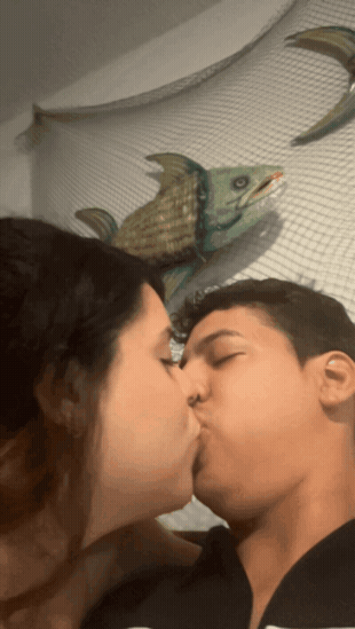 Man And Woman Kissing In Front Of Fish GIF