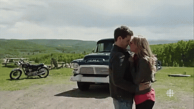 Man And Woman Kissing In Front Of GMC Truck GIF