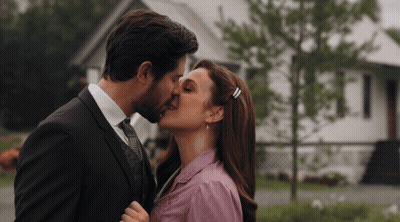 Man And Woman Kissing In Front Of House GIF