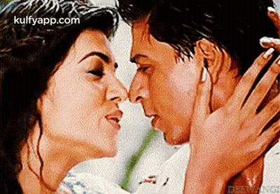 Man And Woman Kissing In Front Of Kulfyapp.com GIF