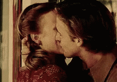 Man And Woman Kissing In Front Of Mirror GIF