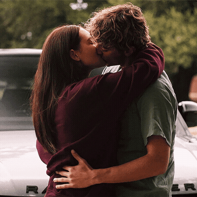 Man And Woman Kissing In Front Of Range Rover GIF