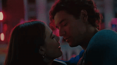 Man And Woman Kissing In Front Of Red Light GIF