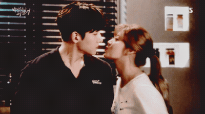 Man And Woman Kissing In Front Of SBS Sign GIF
