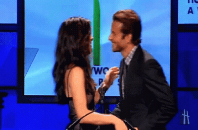Man And Woman Kissing In Front Of Screen Saying Two GIF