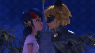 Man And Woman Kissing In Front Of Statue GIF