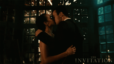 Man And Woman Kissing In Front Of The Invitation Sign GIF